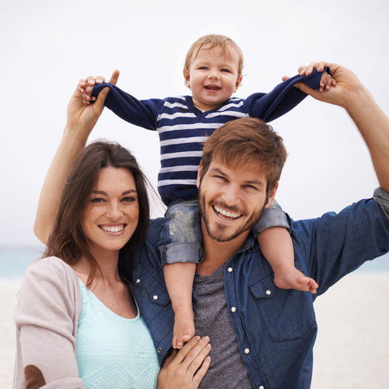 family on beach smiling